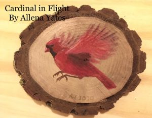 Cardinal painted on a small wood slice